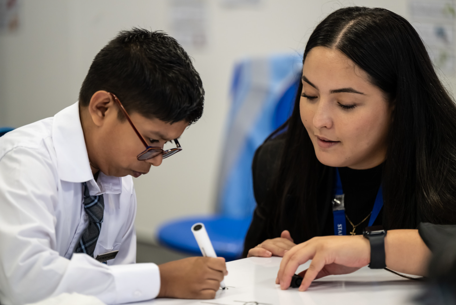 A teacher guiding a student through their work.