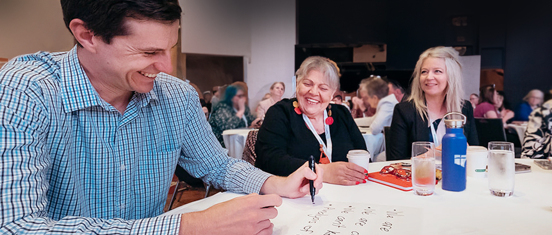 Teachers working at tables at Conference 