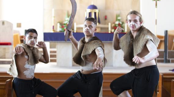 Three Aboriginal boys in traditional dress in the Catholic Church.