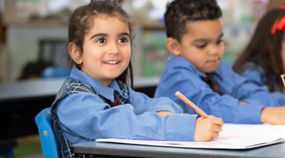 Students writing in a classroom.