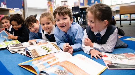 A group of kids reading picture books.