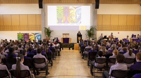 A school assembly of the blessing of a new school building.