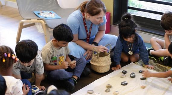 Kids learning by playing with rocks.