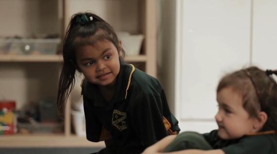 Two young girls in class.