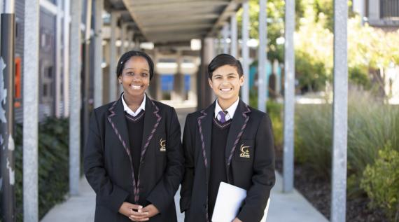 Two high school students in their uniforms.