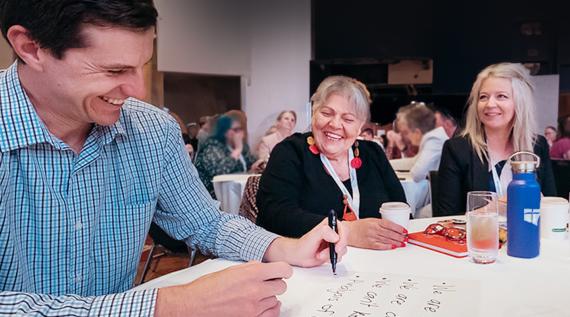 Teachers working at tables at Conference 