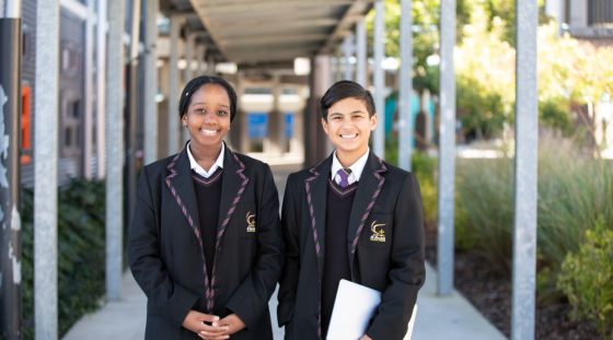 Two senior students out the front of a Catholic school.