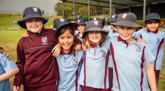 Four students smiling at the camera.