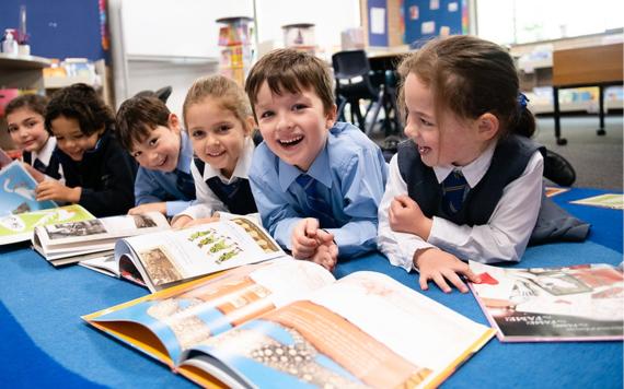 A group of kids reading picture books.