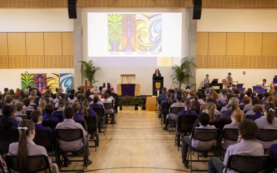 A school assembly of the blessing of a new school building.