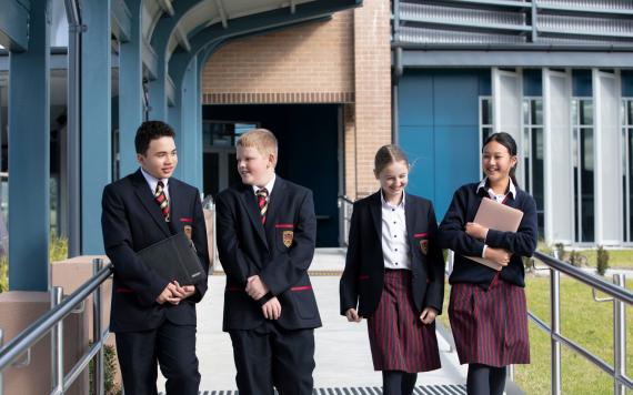 A group of high school students walking through the school.