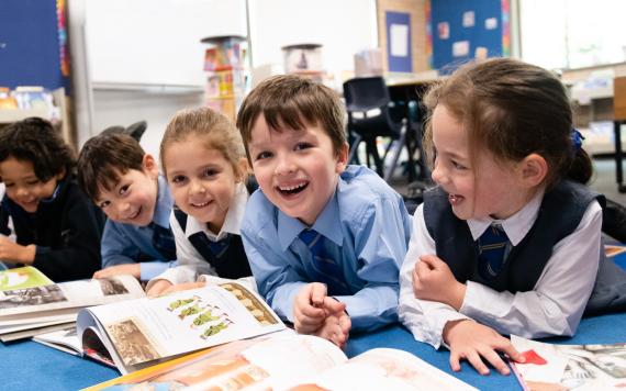 Kids reading books on the floor.