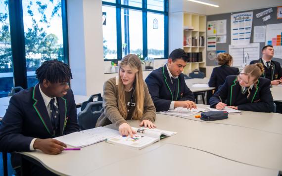 A teacher with high school students in class.