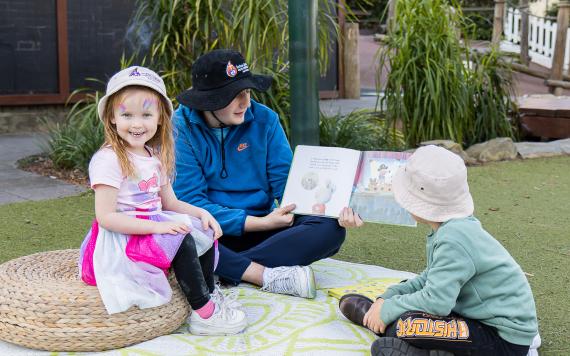 Preschooler reading in garden